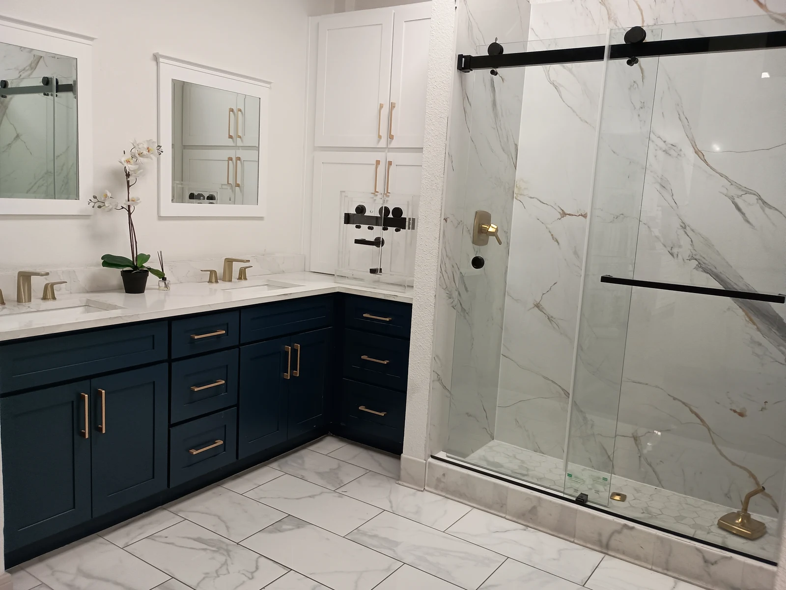 Blue shaker double bathroom vanity with marble countertop and glass shower