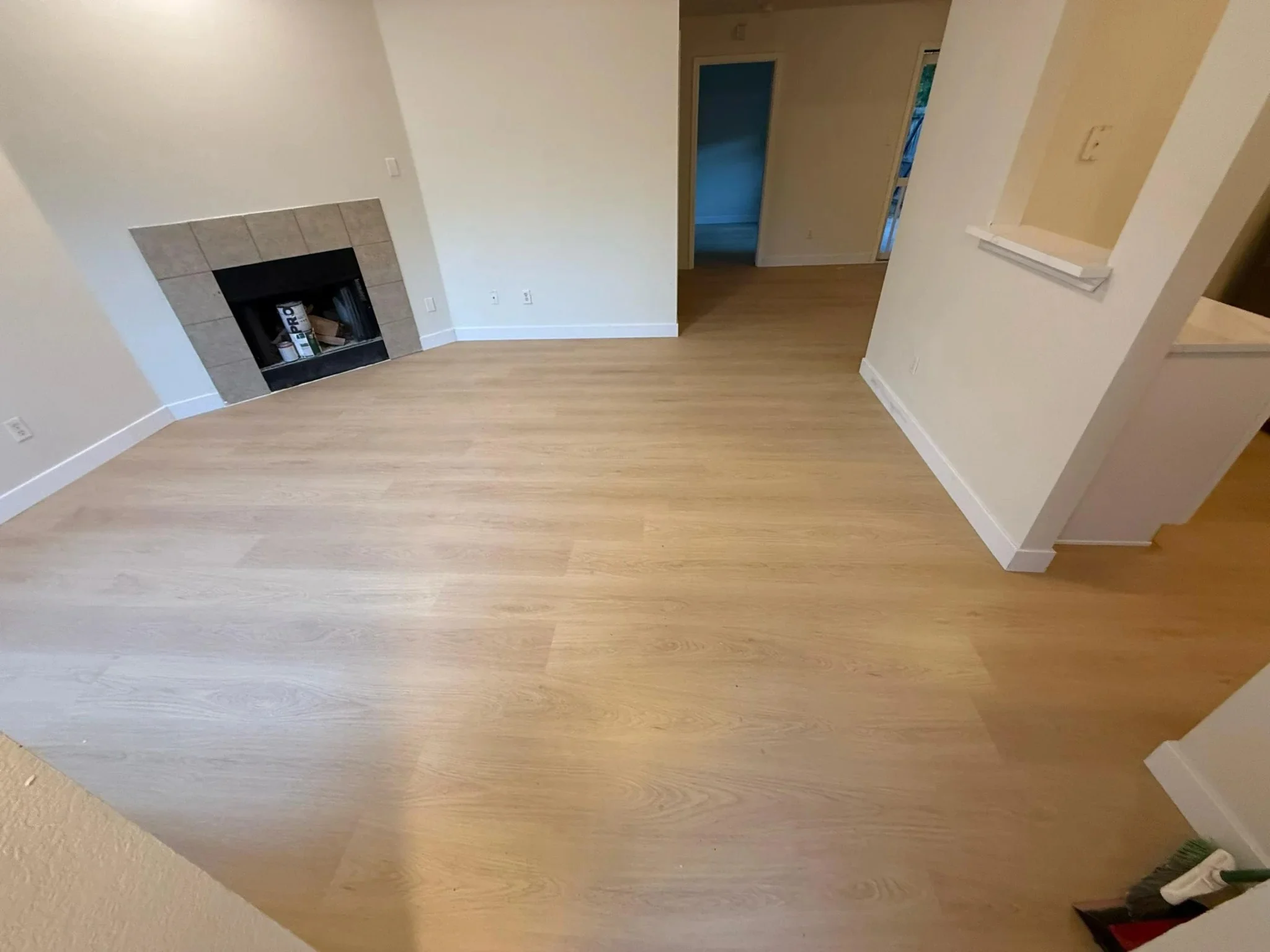 Living room with fireplace and light oak plank flooring