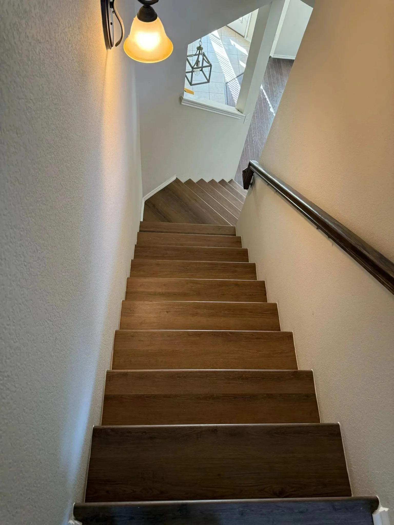 Staircase with warm wood-look plank flooring