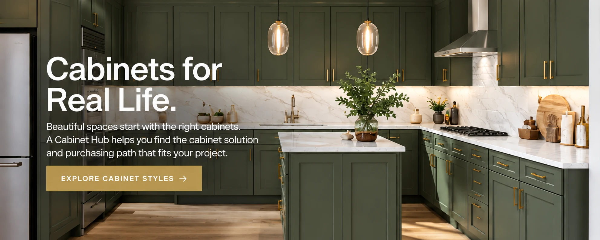 Green shaker kitchen with brass hardware, marble countertops and a marble island