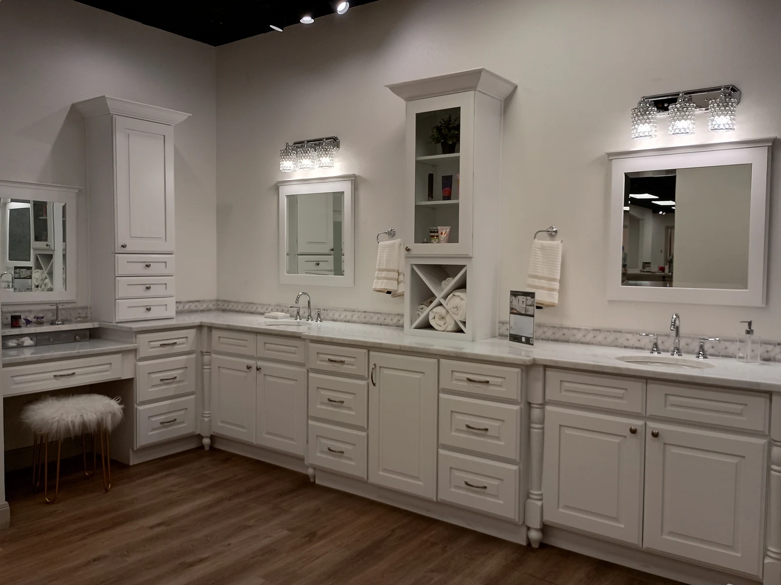 White bathroom vanity with linen tower and vessel sinks