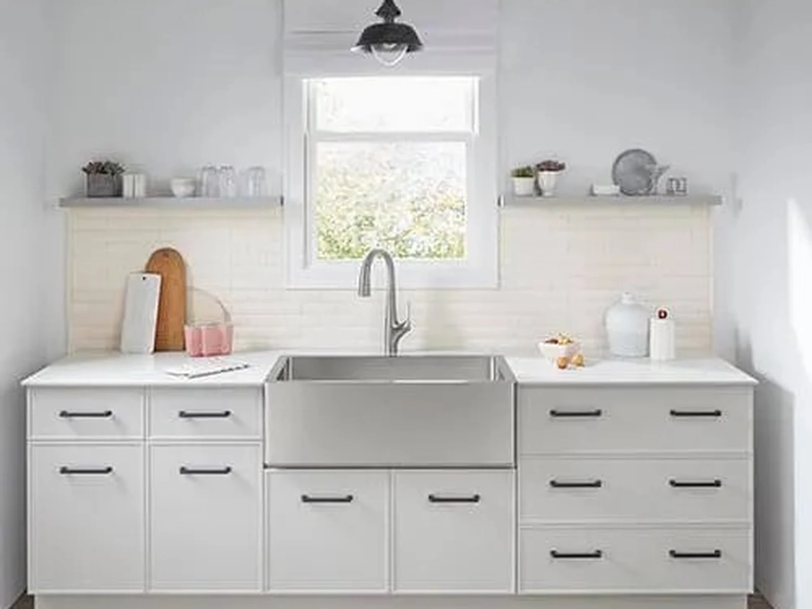 Slim Shaker White kitchen cabinetry with stainless farmhouse sink