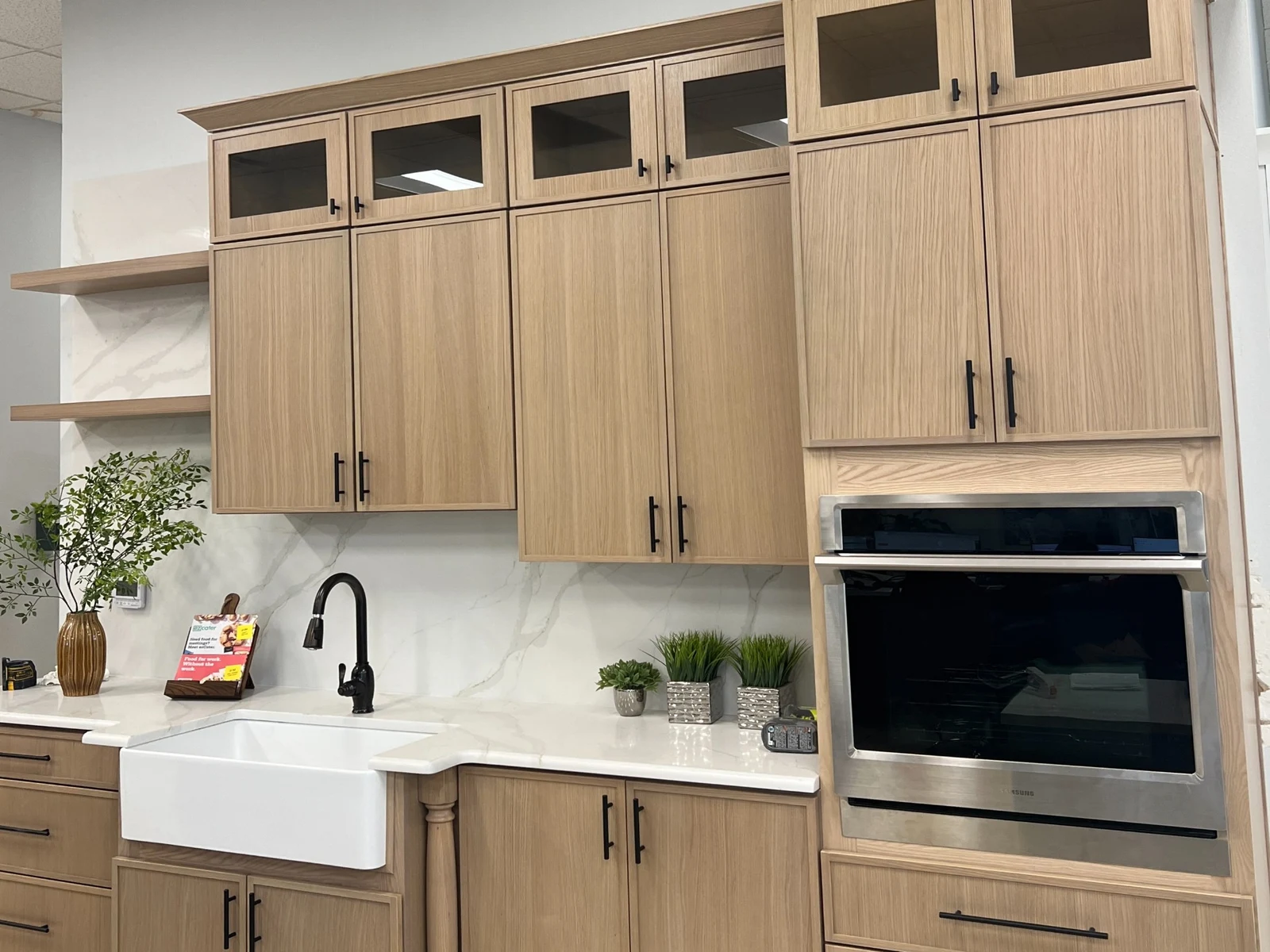 Slim White Oak kitchen cabinetry with glass upper doors
